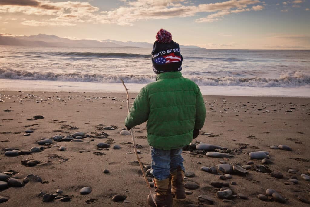 Child on a beach by the ocean